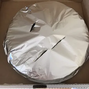 Foil wrapped pizza to keep warm