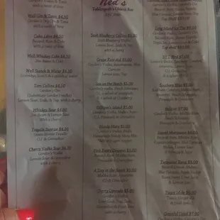 a hand holding a menu