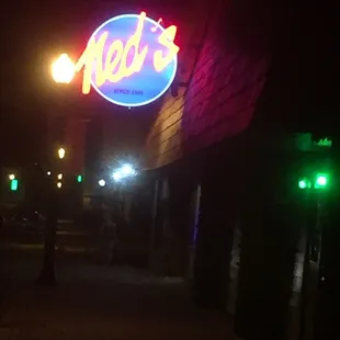 a neon sign on the side of a building