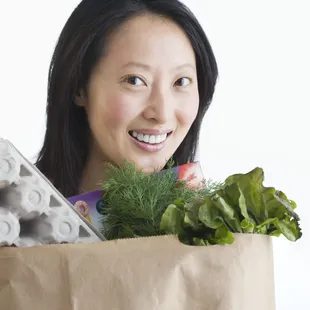 a woman holding a grocery bag