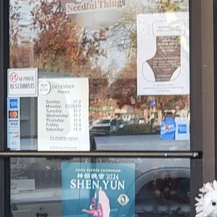 Needful Things front door. It shows the hours of operation.