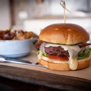 a burger and a bowl of fries