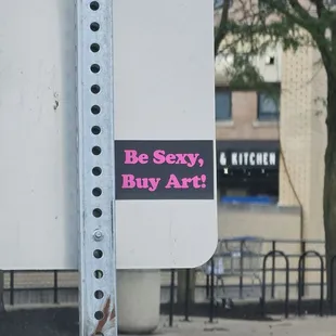 Sticker on a sign in the parking lot