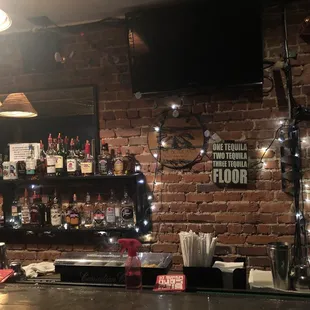 a bar with a brick wall