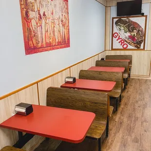 a row of red tables in a restaurant