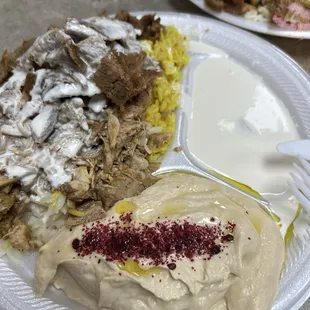 Chicken and lamb with rice, hummus, and garlic sauce