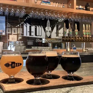 three glasses of beer on a bar