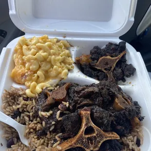 Oxtails beans and rice, macaroni and cheese. Sorry I ate some of the oxtails because they were just so good before I took the picture.