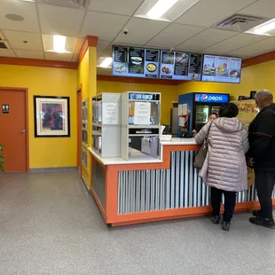 a man and a woman standing at a counter