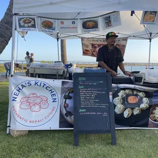 a man and a woman standing under a tent