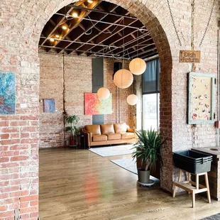 a living room with exposed brick walls