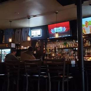 a bar with multiple televisions