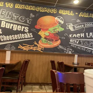 a chalkboard with a burger and cheesesteaks on it