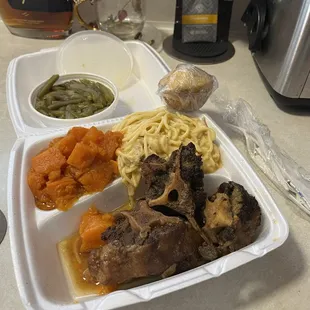 Green beans, chicken tetrazzini, oxtails, cornbread, and sweet potatoes.
