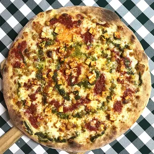 Rotating Pizza Lab: &quot;Holla for Masala&quot;

Red sauce base with aged mozz, paneer tikka masala, roasted chickpeas, and green curry drizzle
