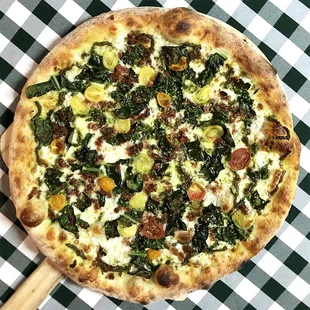 Rotating Pizza Lab: &quot;Sue&apos;s Garden&quot; 

Pistachio pesto base, aged mozz, bacon, Tuscan kale and heirloom baby tomatoes.