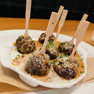 a plate of appetizers with meatballs