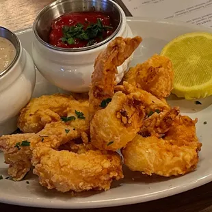 a plate of fried shrimp and dipping sauce