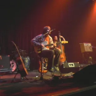 a man playing a guitar on stage