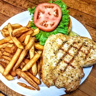 Grilled chicken sandwich served with a side of french fries