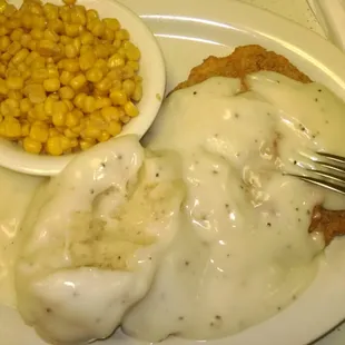 Chicken fried steak with mashed potatoes and gravy.