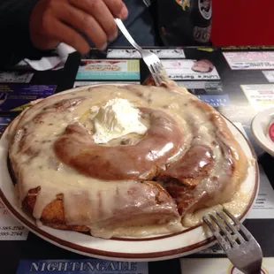 The cinnamon roll is as big as the dinner plate!