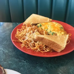 Ham, spinach and cheese omelet, hash browns, and wheat toast.
