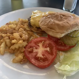 a hamburger, macaroni and cheese, lettuce, and tomato