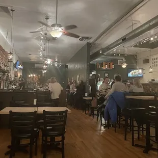 people sitting at tables in a restaurant