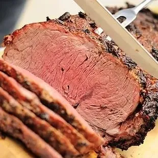 a person slicing a roast