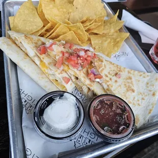 quesadilla and chips on a tray