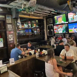 a large group of people sitting at a bar