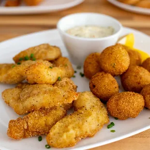 a plate of fried tater tots and dipping sauce