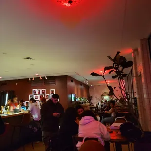 people sitting at tables in a restaurant