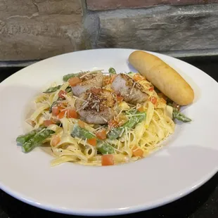 a plate of pasta with meat and vegetables
