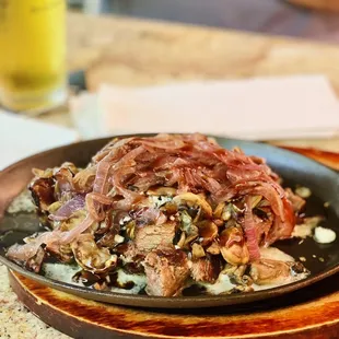 New York steak bites with blue cheese, caramelized onions and sautéed mushrooms