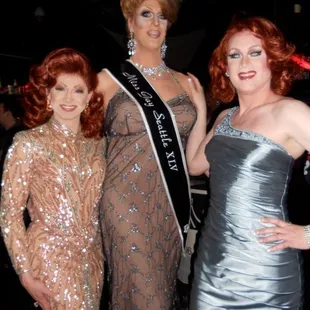 three women dressed in evening gowns