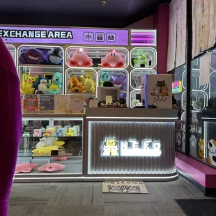 Right by the front where a cashier is to help you buy tokens or exchange plushies