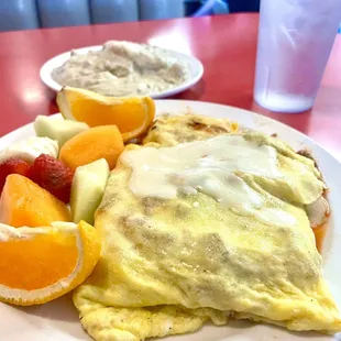 Guido omelette filled with linguisa sausage, marinara and mozzarella cheese accompanied by fruit and biscuit and gravy.