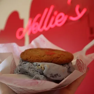 a hand holding an ice cream sandwich