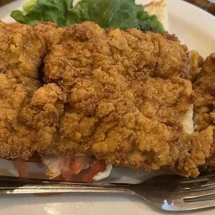 Pork tenderloin so big you can't see the sandwich underneath!