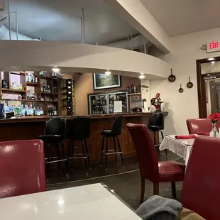 a bar with red chairs