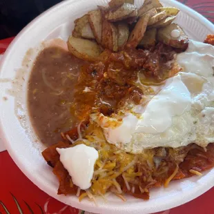 Chilaquile plate (over easy eggs beans papas ) Plate comes with rice and beans but it was accommodated potatoes