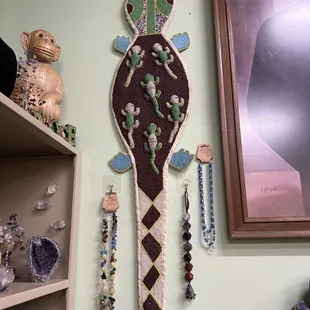 Hand beaded reptile next to sons lovely handmade jewelry