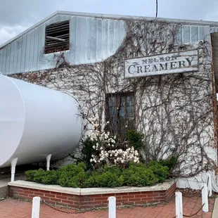 a large white barrel in front of a building