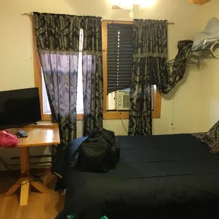 a man standing in front of a bed