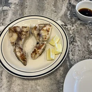 Hamachi (grilled yellowtail collar) with ponzu-thin soy dipping sauce)