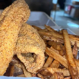 a basket of fried fish and fries