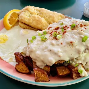 Country Fried Steak with Country Gravy, eggs over-easy, potatoes, and housemade biscuit