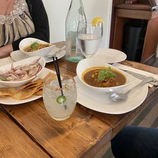 a woman sitting at a table with food